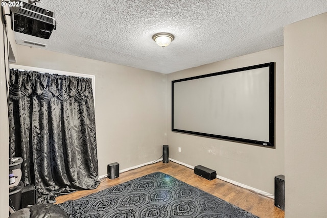 11635 NW Seavey Rd, Forest Grove, OR 97116 - cinema room featuring wood finished floors, a textured ceiling, and baseboards
