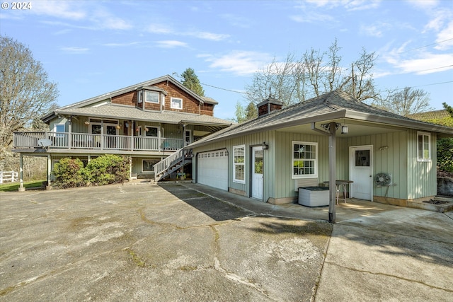 11635 NW Seavey Rd, Forest Grove, OR 97116 - view of front of home featuring driveway, a garage, covered porch, stairway, and a shingled roof