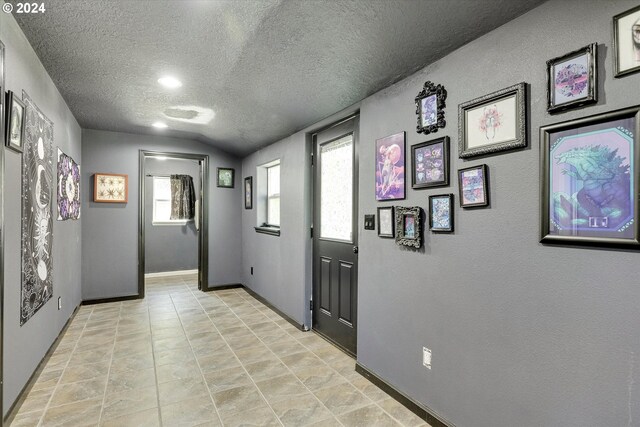 11635 NW Seavey Rd, Forest Grove, OR 97116 - entrance foyer with a textured ceiling, baseboards, lofted ceiling, and a textured wall