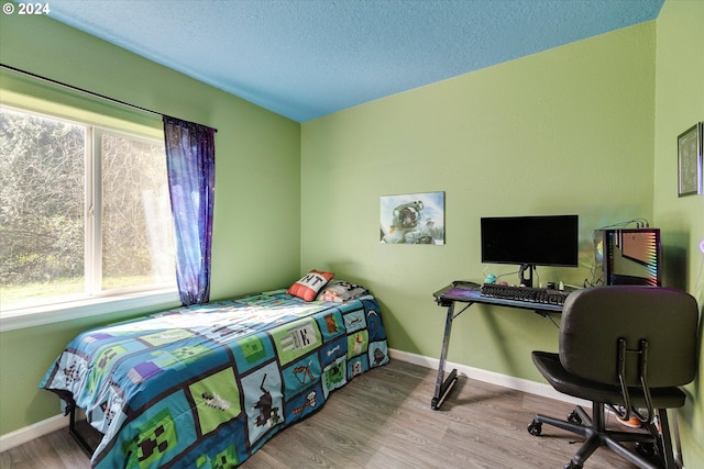 11635 NW Seavey Rd, Forest Grove, OR 97116 - bedroom featuring a desk, wood finished floors, a textured ceiling, and baseboards