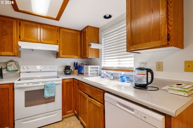 kitchen featuring white appliances and sink