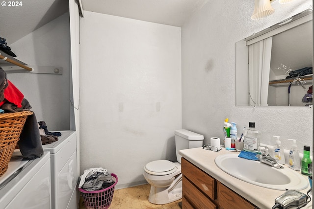 bathroom featuring independent washer and dryer, vanity, toilet, and hardwood / wood-style floors