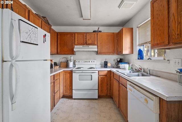 kitchen featuring white appliances and sink