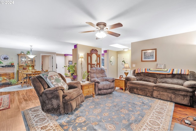 living room with wood-type flooring and ceiling fan