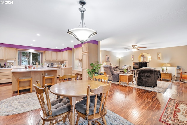 dining space featuring ceiling fan and light wood-type flooring