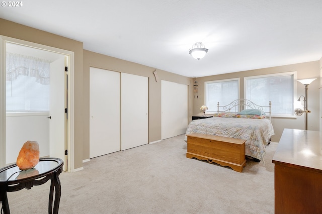 carpeted bedroom featuring two closets