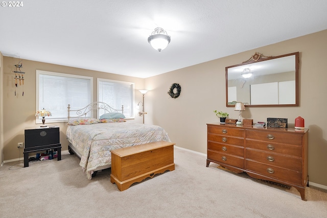 bedroom with light colored carpet