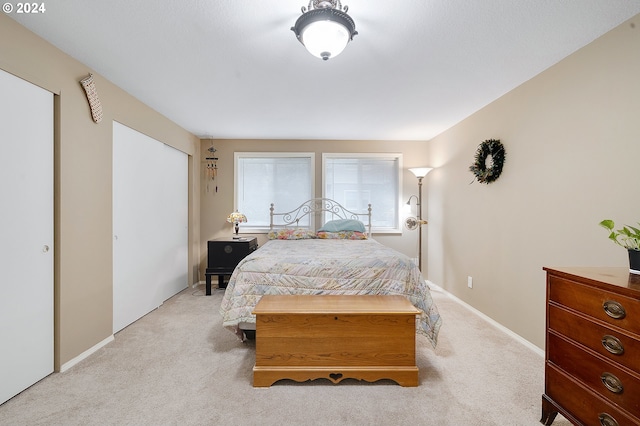 bedroom featuring light carpet