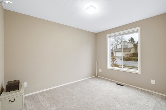 unfurnished room featuring light colored carpet