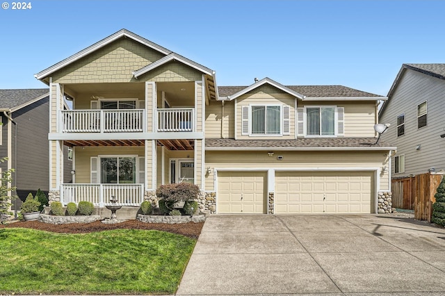 view of front facade featuring a balcony, a garage, and a front lawn