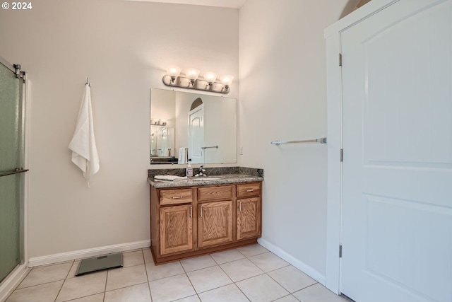 bathroom featuring vanity, an enclosed shower, and tile patterned floors