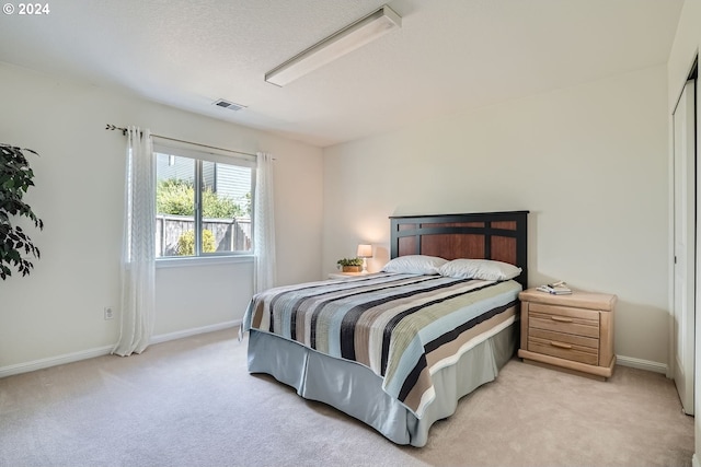 carpeted bedroom with a textured ceiling