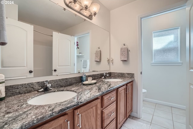 bathroom with tile patterned flooring, toilet, and vanity