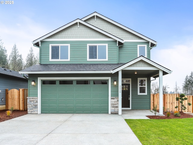 craftsman inspired home featuring a front yard and a garage