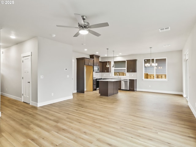 unfurnished living room with light hardwood / wood-style floors, sink, and ceiling fan with notable chandelier