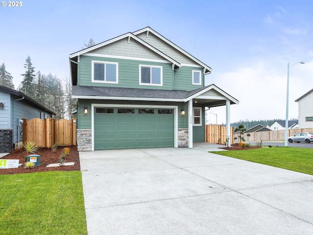 craftsman-style house featuring a front yard and a garage