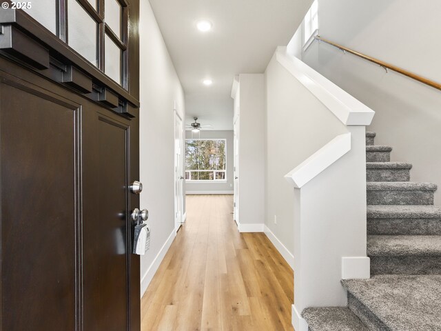 entryway with light wood-type flooring and ceiling fan