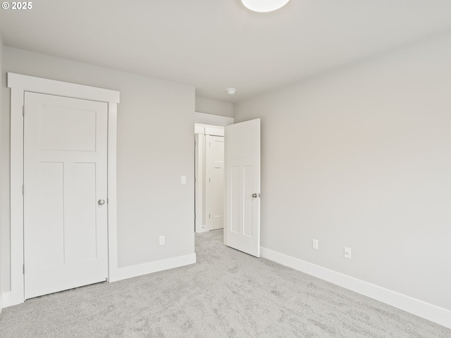 unfurnished bedroom with a textured ceiling, a closet, and light carpet