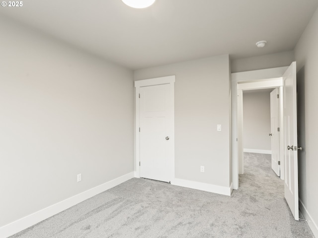 unfurnished bedroom featuring light carpet