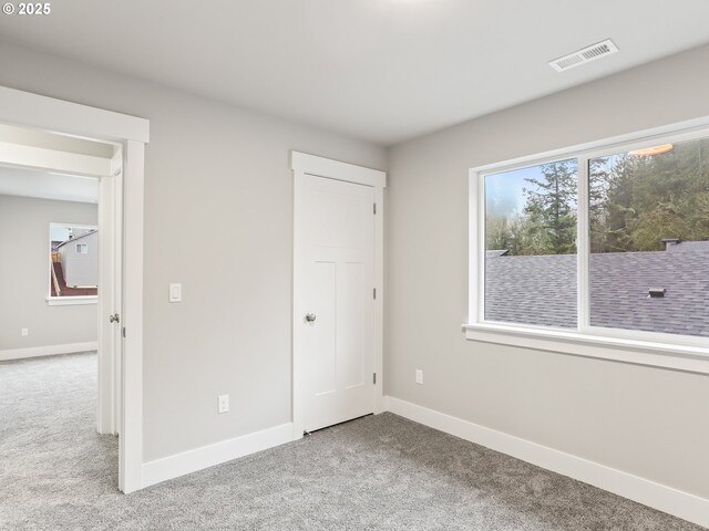 unfurnished bedroom featuring light colored carpet