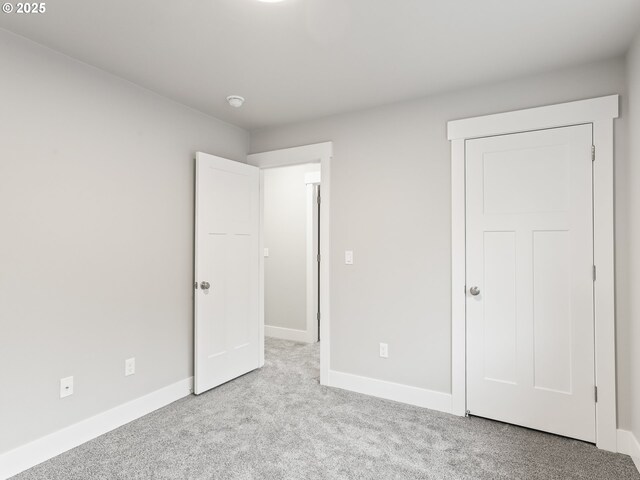 unfurnished bedroom featuring light colored carpet