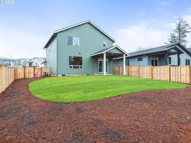 back of property featuring a lawn and central air condition unit