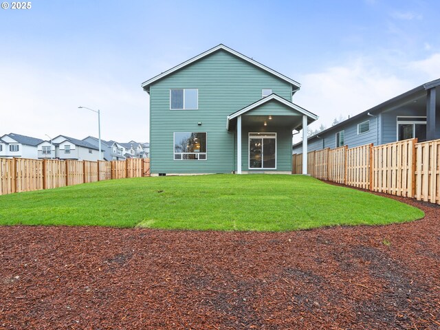 back of house with a yard