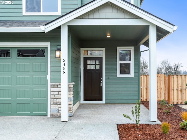 entrance to property featuring a porch and a garage