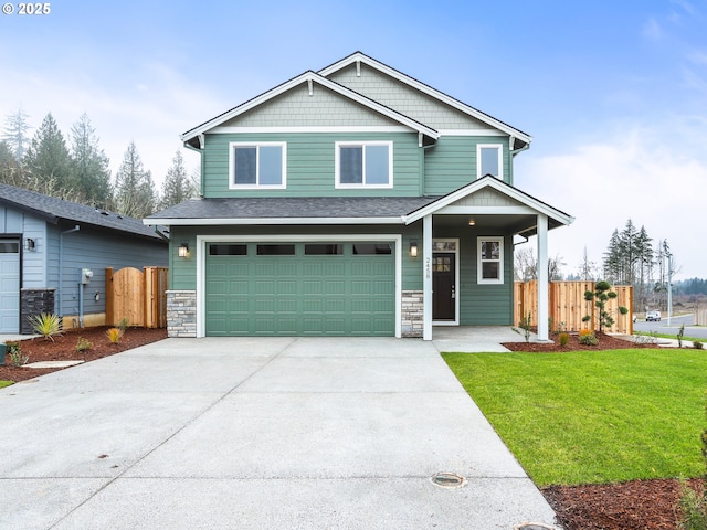 craftsman-style home with a front lawn and a garage