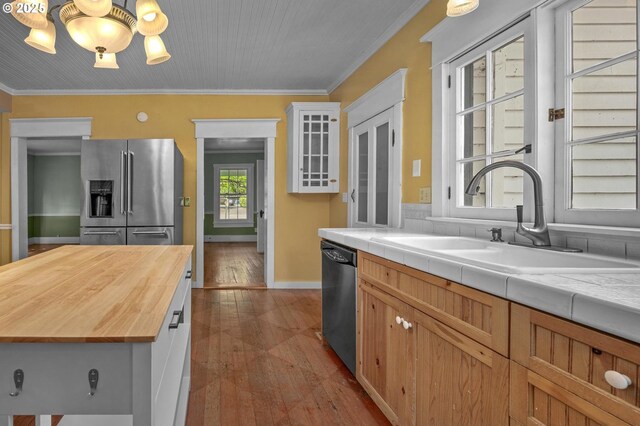unfurnished living room featuring visible vents, ornamental molding, wood-type flooring, and a notable chandelier