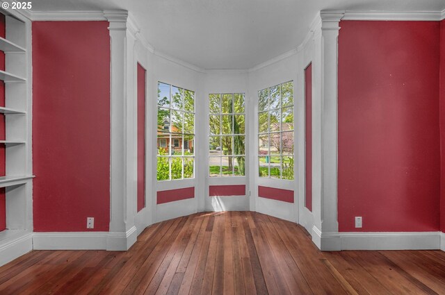 empty room with carpet floors, baseboards, and ornamental molding