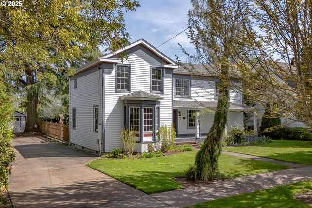traditional-style home with an outbuilding, a front lawn, and driveway