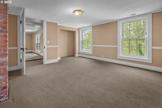 unfurnished bedroom with baseboards, carpet, and ornate columns