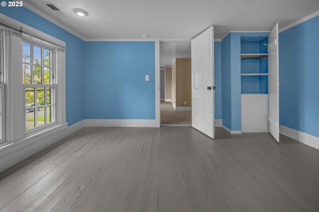 full bath featuring visible vents, wood finished floors, baseboards, toilet, and tub / shower combination