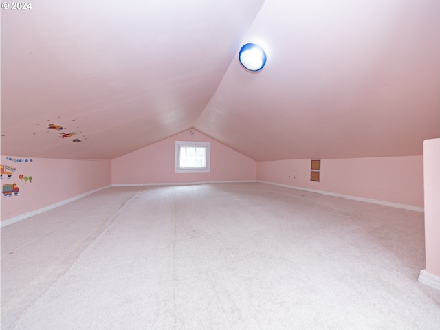 bonus room featuring carpet and vaulted ceiling