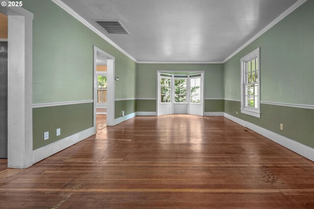 unfurnished sunroom with plenty of natural light, ornamental molding, and hardwood / wood-style flooring