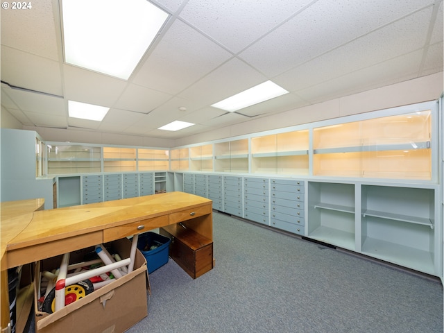 office featuring a paneled ceiling, dark carpet, and a mail area