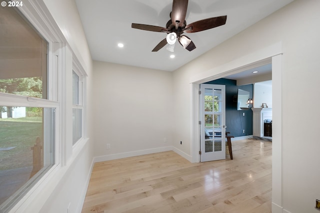 spare room featuring ceiling fan and light hardwood / wood-style flooring