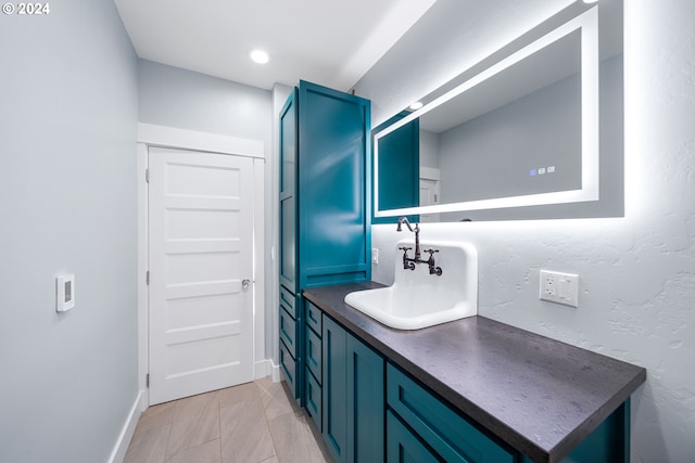 bathroom with tile patterned flooring and vanity