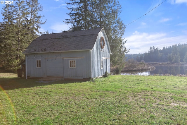 exterior space with a water view and a lawn