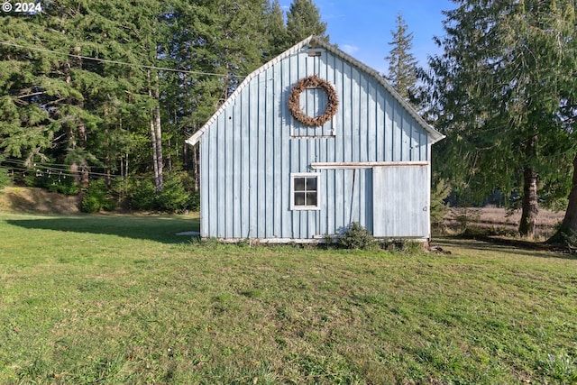 view of outdoor structure featuring a lawn