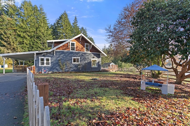 view of side of property with a carport