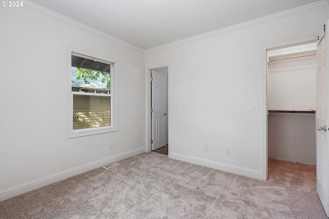 unfurnished bedroom featuring light carpet, a closet, and ornamental molding