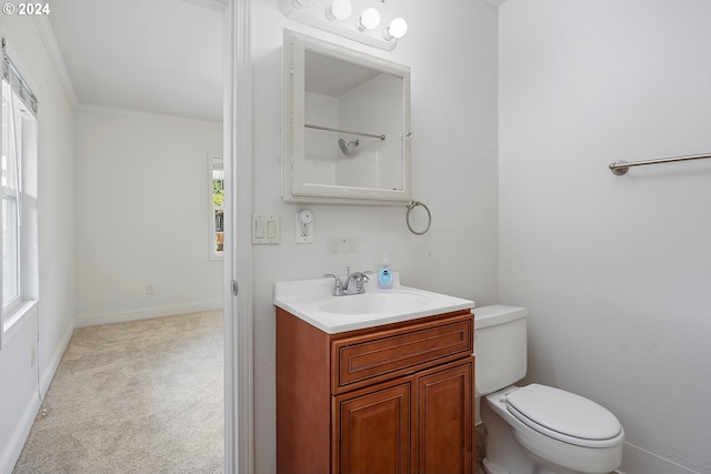 bathroom with vanity, ornamental molding, and toilet