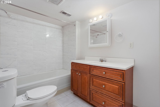 full bathroom featuring toilet, tiled shower / bath, vanity, and tile patterned flooring