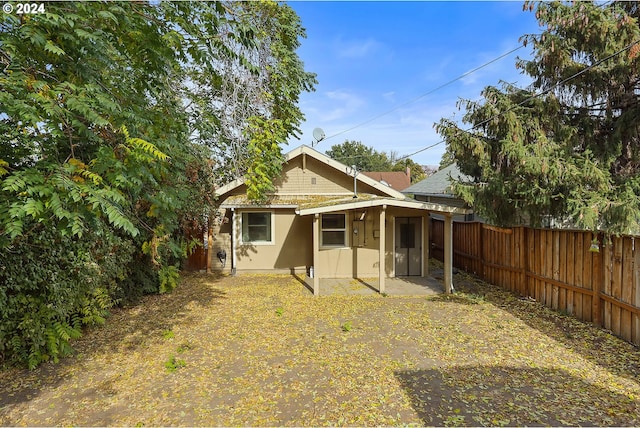 back of house with a patio