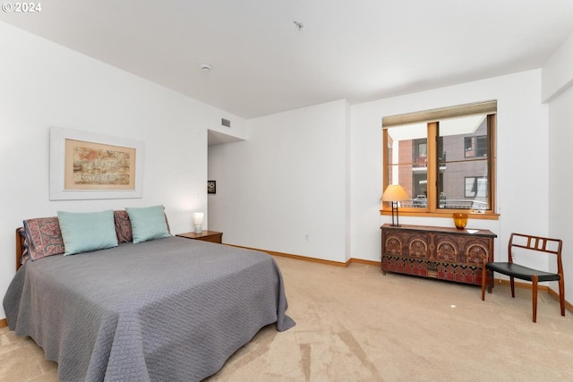 bedroom with light colored carpet