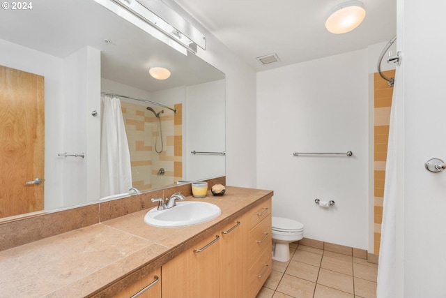 full bathroom featuring toilet, vanity, tile patterned floors, and shower / tub combo with curtain