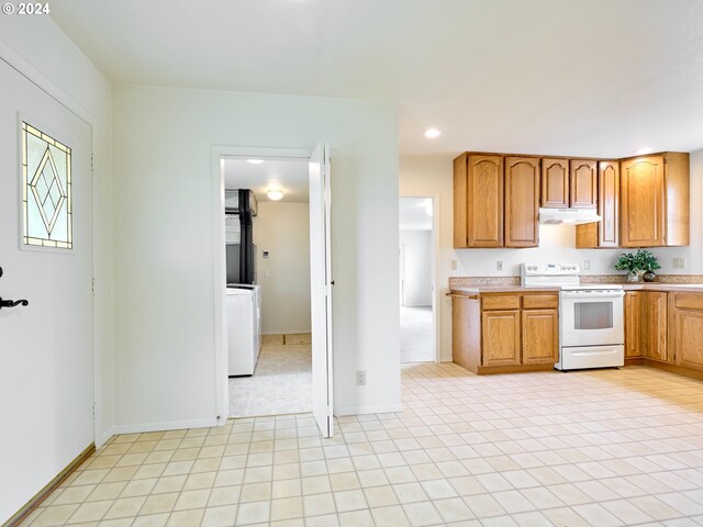 328 Mill St, Silverton, OR 97381 - kitchen featuring recessed lighting, under cabinet range hood, light countertops, washer / dryer, and white range with electric cooktop