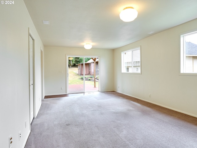 unfurnished room featuring carpet